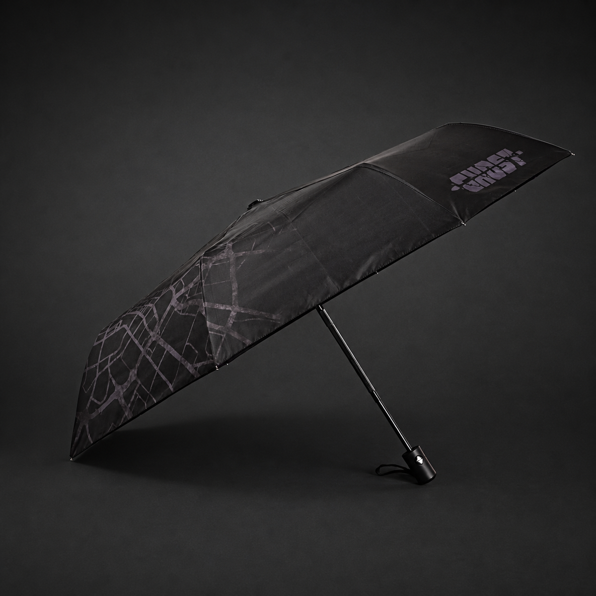 Side view of the open automatic folding umbrella showing its black outer canopy and map pattern