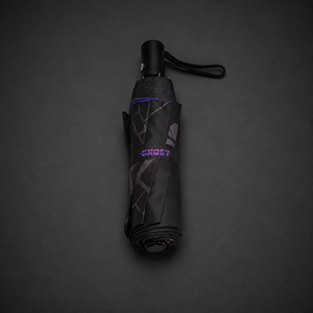 Folded Manchester Rainy Night automatic umbrella with black handle, wrist strap and printed fastening band.