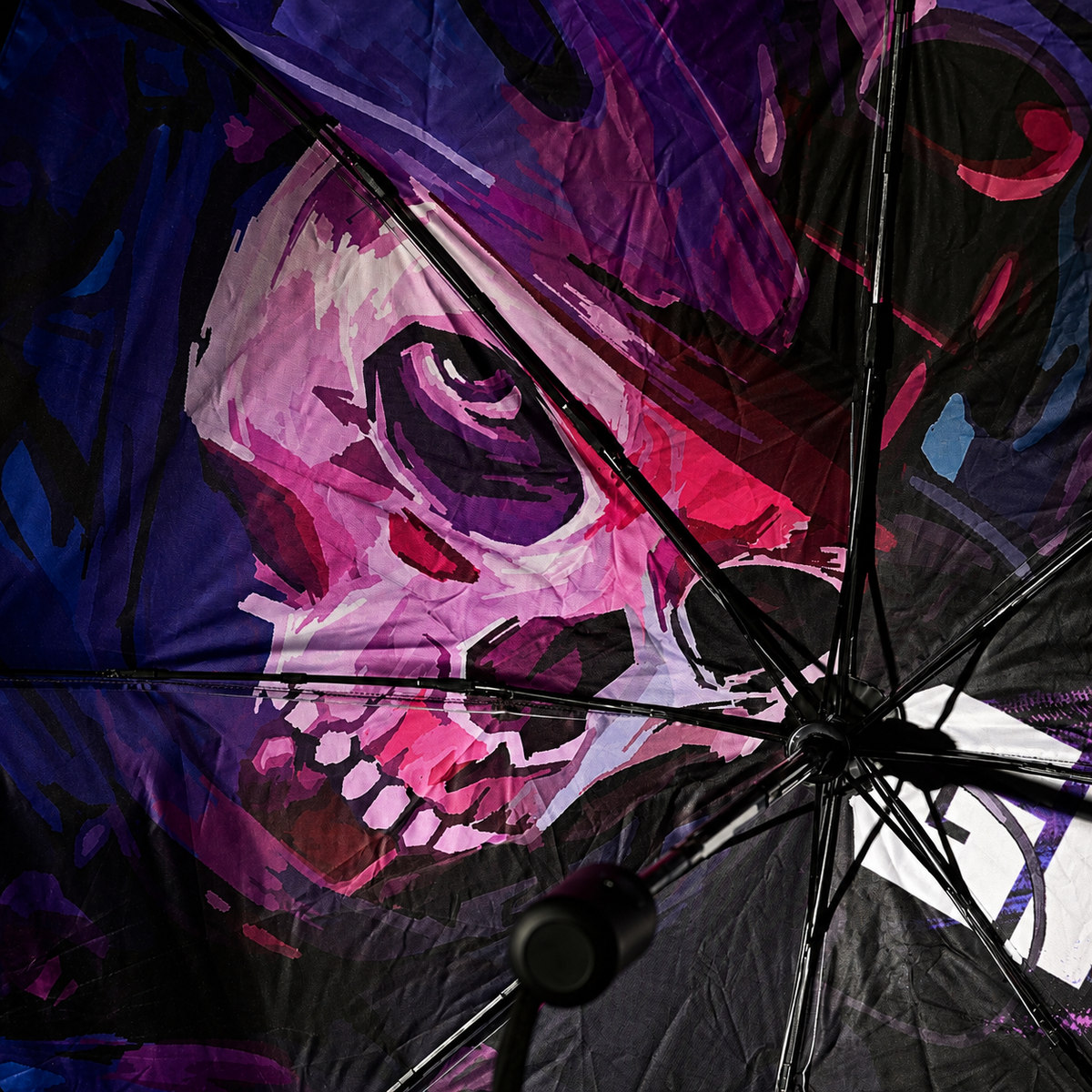 Close-up of the umbrella interior showing purple and blue skull-masked character artwork
