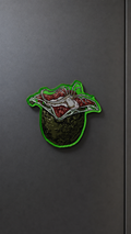 Alien Egg-inspired metal fridge magnet with a green egg and open fleshy interior design
