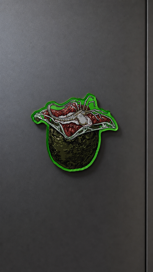 Alien Egg-inspired metal fridge magnet with a green egg and open fleshy interior design