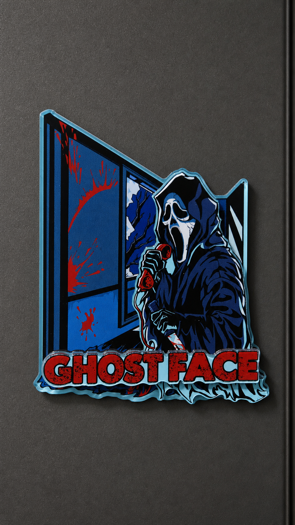Ghost Face-inspired metal fridge magnet with a blue hooded figure and red lettering