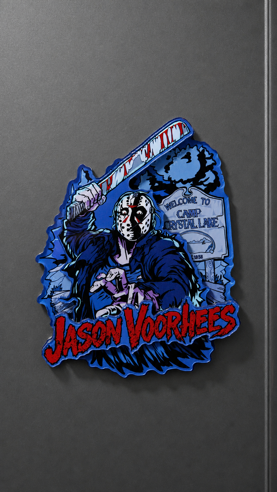 Jason Voorhees-inspired metal fridge magnet with a masked figure, machete, and red lettering