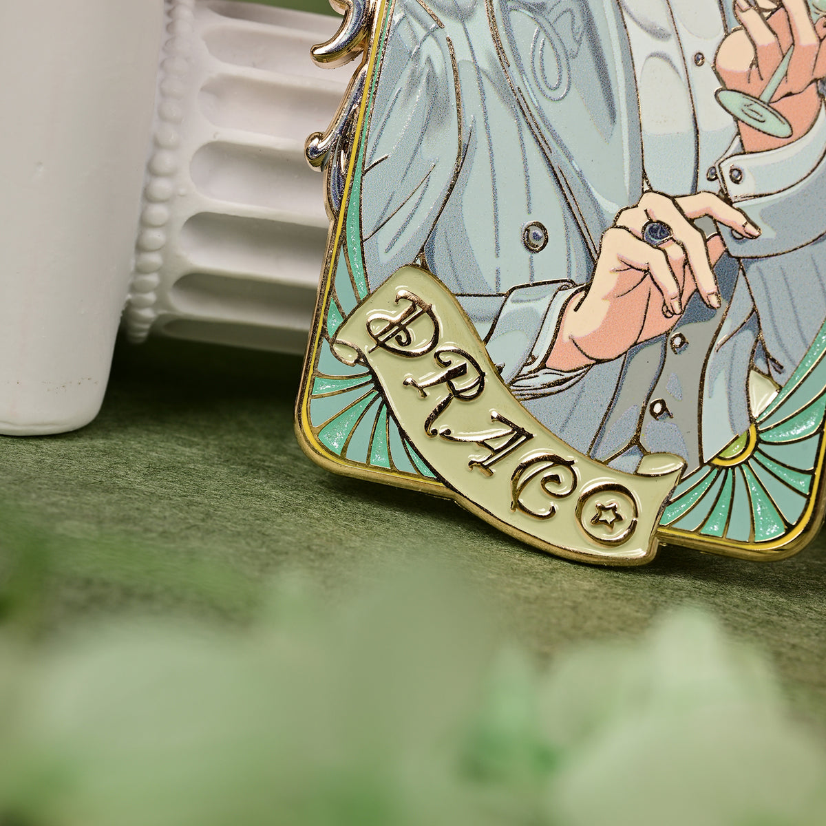 Close-up of the lower front of the Jazz Age 1920 Darco enamel pin showing the suit, hands, and PRACO banner