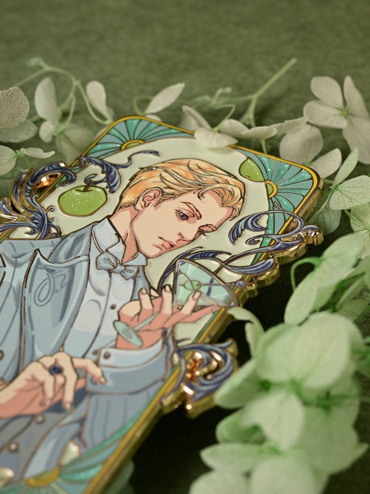 Close-up of the Jazz Age 1920 Darco enamel pin with a cocktail glass and pale green floral styling